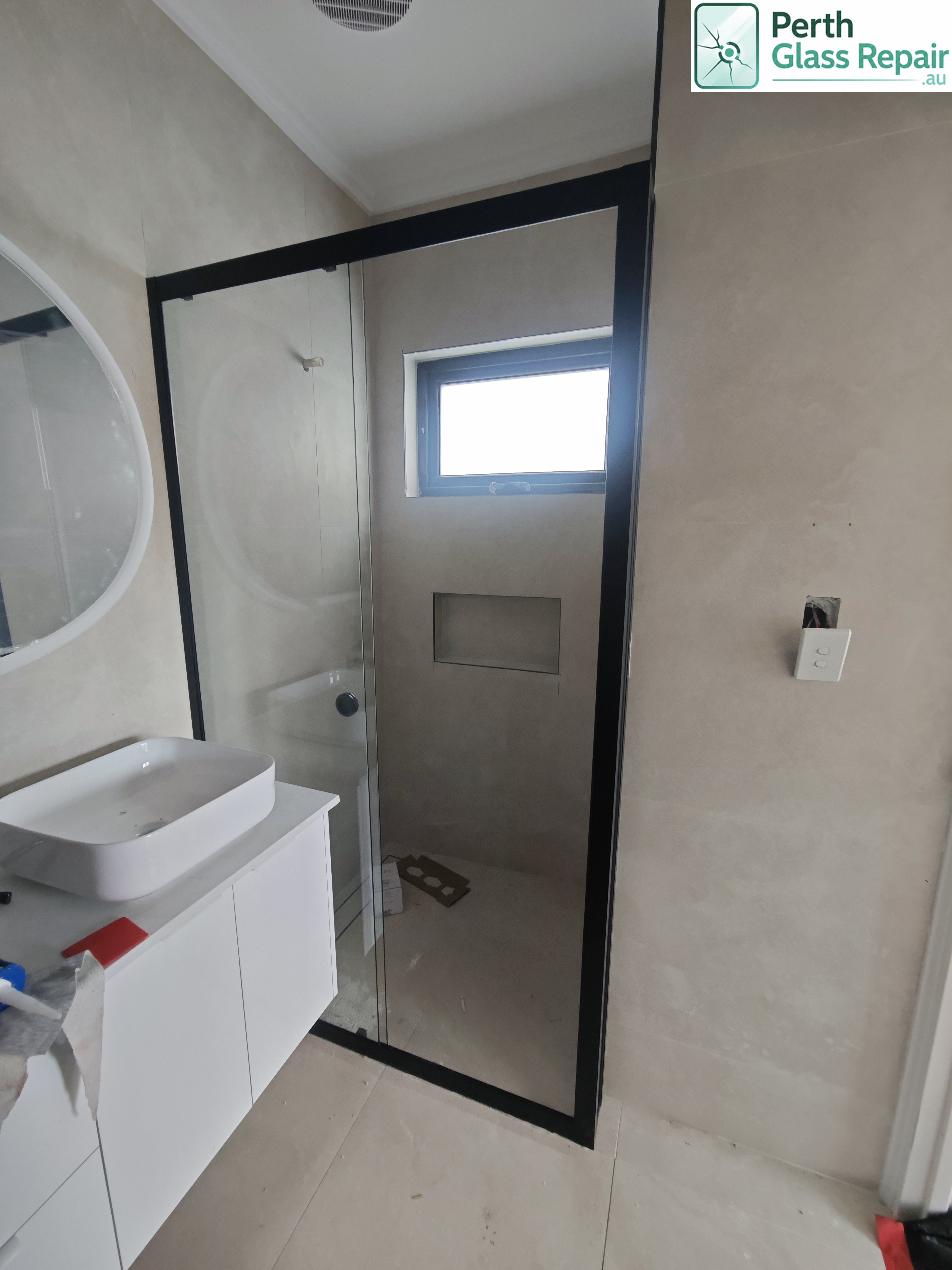 Black semi-frameless shower screen installed by Perth Glass Repair