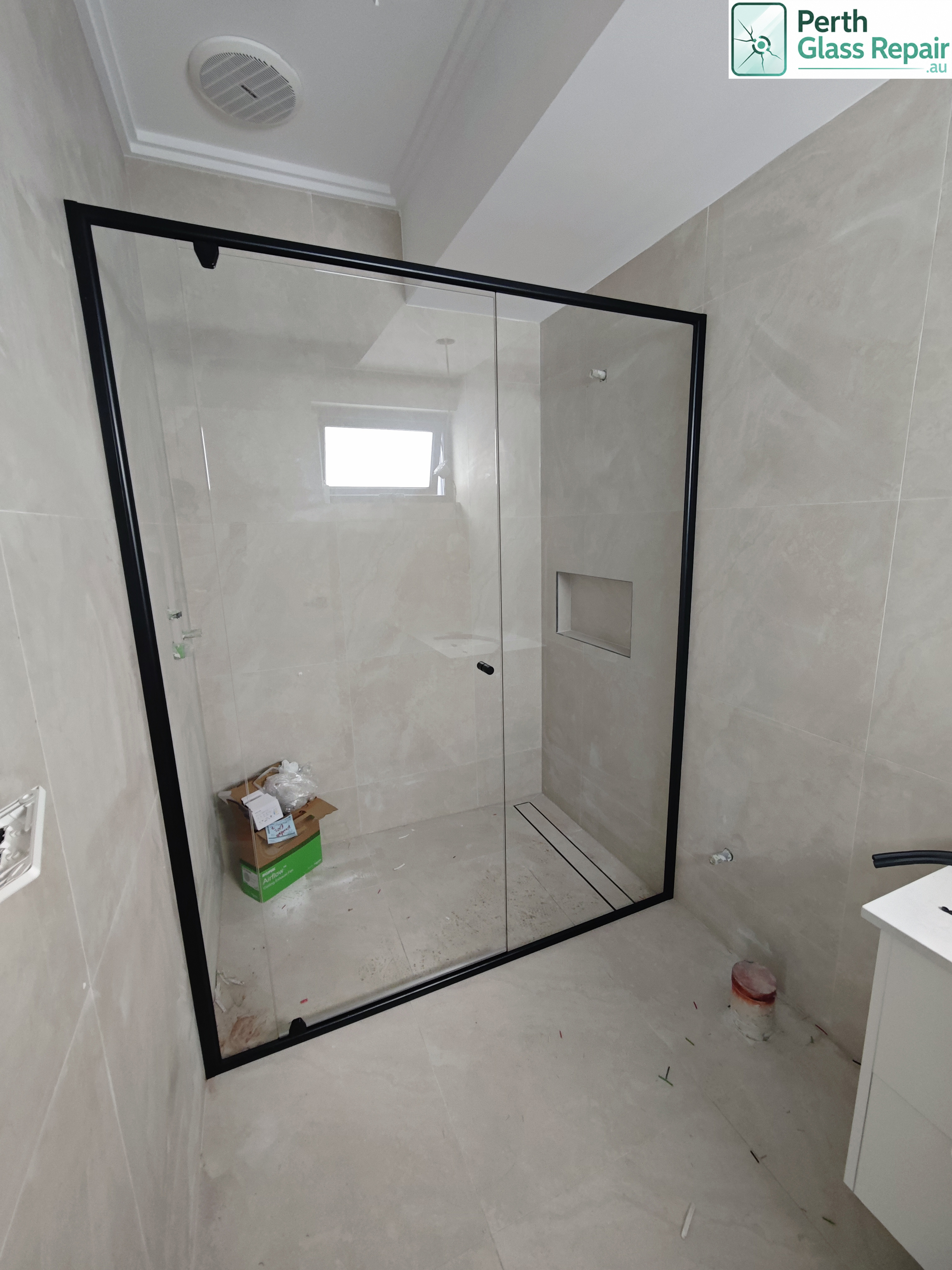 Semi-frameless black shower screen installed by Perth Glass Repair